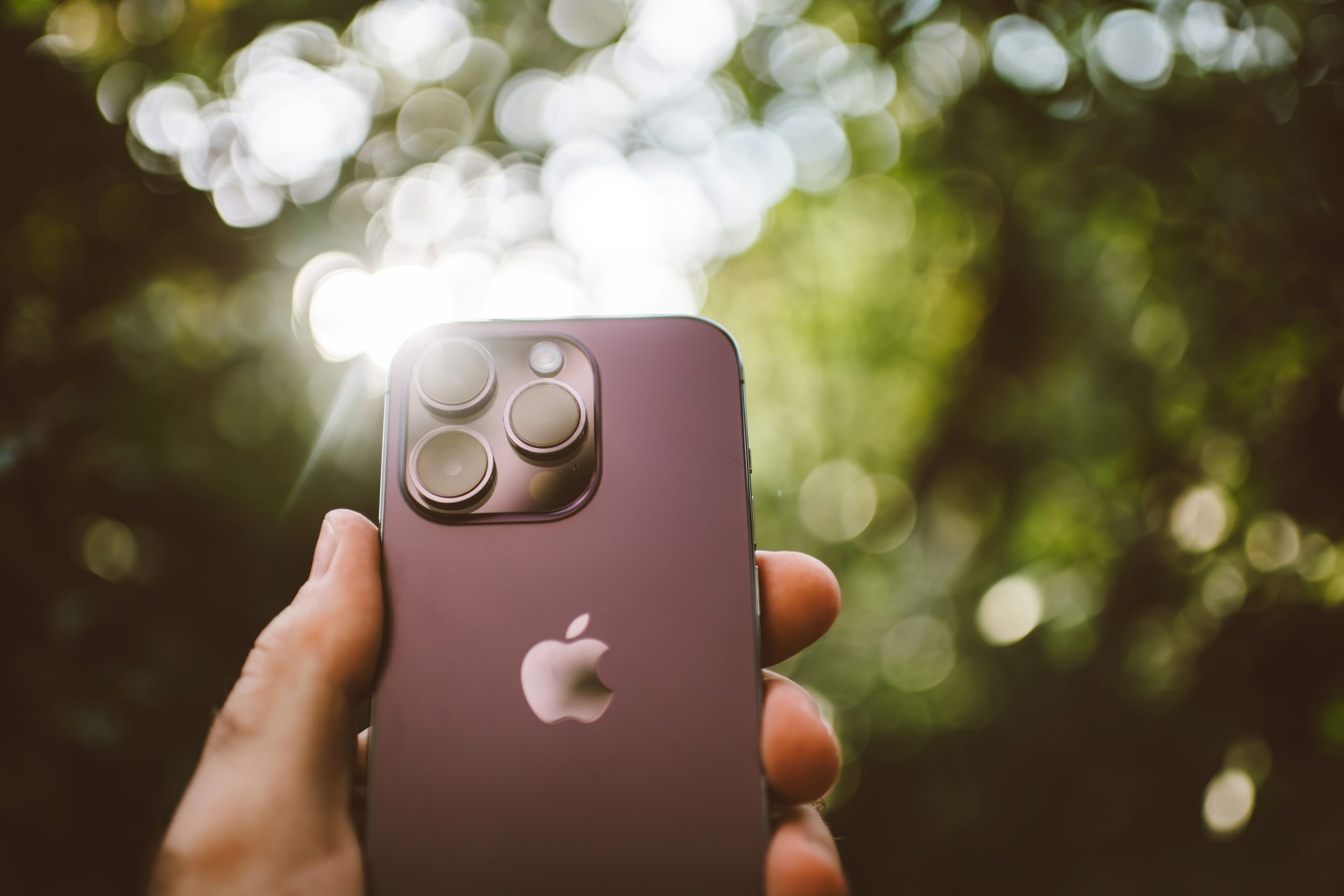 A person holding up an iPhone.